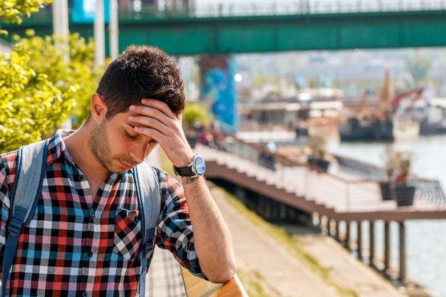 Businessman in depression with hands on forehead