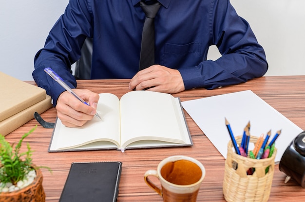 Businessman examines the documents at the desk in the room