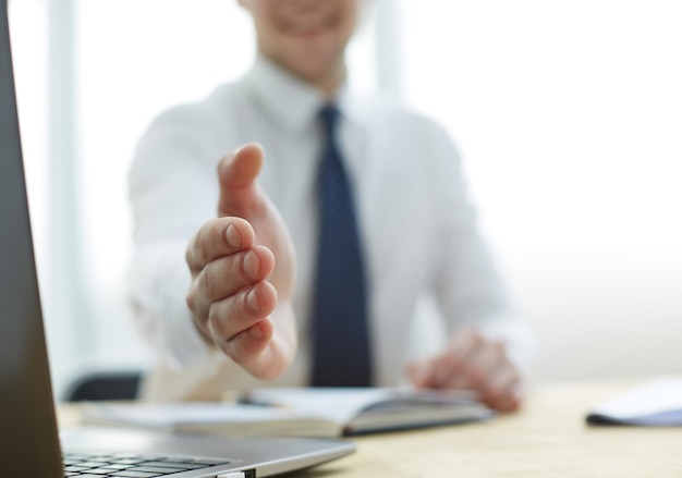 Businessman extending hand to shake