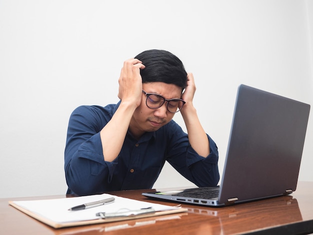 Businessman feels tried with working gesture hold headMan headache with work hard