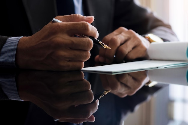 Businessman filling and signing bank cheque ai office