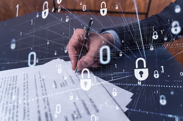 A businessman in formal wear signing the contract to prevent probability of risks in cyber security Padlock Hologram icons over the working desk