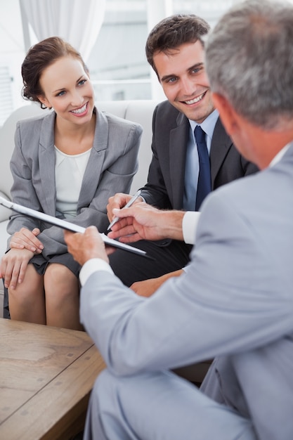 Businessman giving a contract to his partners