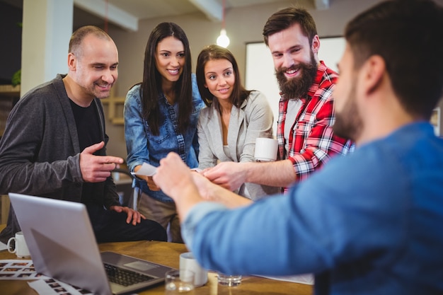 Businessman giving documents to coworkers