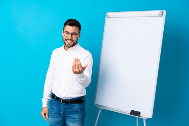 Photo businessman giving a presentation on white board giving a presentation on white board and inviting to come with hand