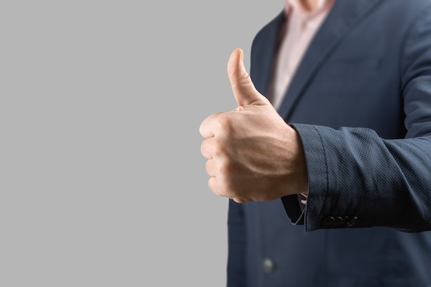 Businessman giving thumbs up as motivation in the office concept