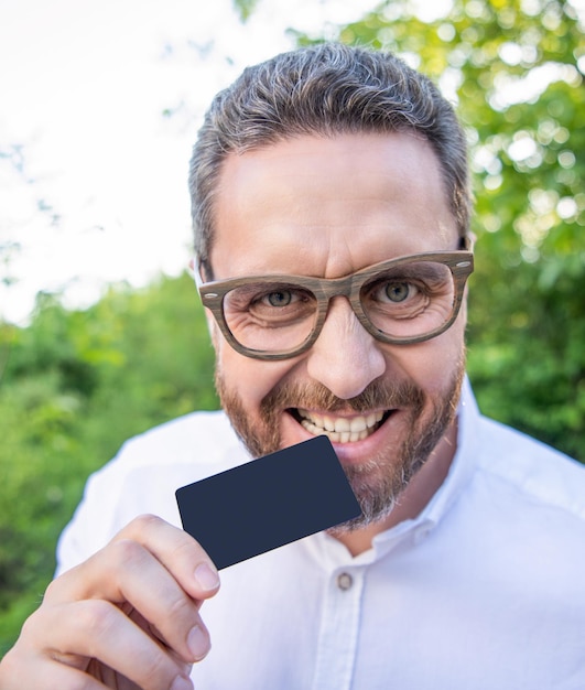 Businessman in glasses bite card businessman with empty card businessman showing debit card