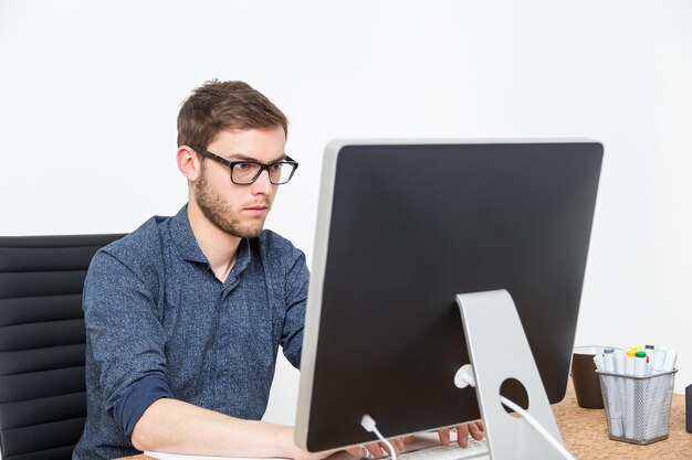 Businessman in glasses typing