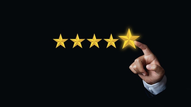 Businessman Hand choosing screen on five star icon to give satisfaction in service rating very impressed. Excellent rating customer service experience. Concept of customer service and satisfaction.