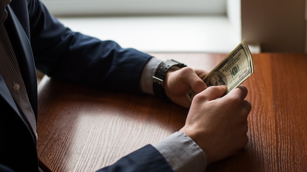 Businessman hand grabbing money