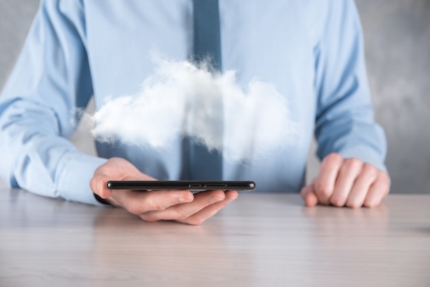 Businessman hand holding cloud.Cloud computing concept, close up of young business man with cloud over his hand.The concept of cloud service.