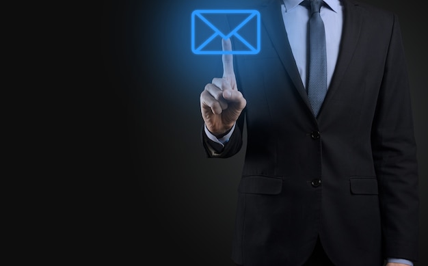 Businessman hand holding e-mail icon, Contact us by newsletter email and protect your personal information from spam mail. Customer service call center contact us concept.