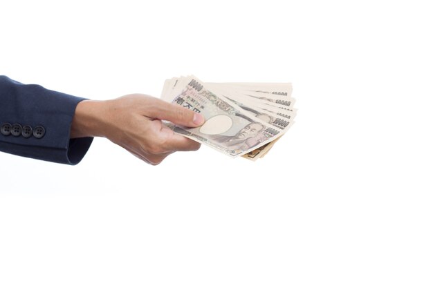 Businessman hand holding Japanese banknote