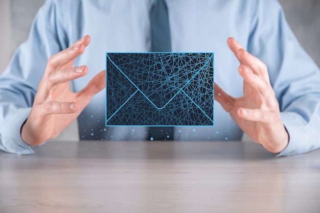 Photo businessman hand holding letter icon,email icons.contact us by newsletter email and protect your personal information from spam mail.customer service call center contact us.email marketing newsletter.