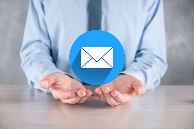 Businessman hand holding letter icon,email icons.Contact us by newsletter email and protect your personal information from spam mail.Customer service call center contact us.Email marketing newsletter.