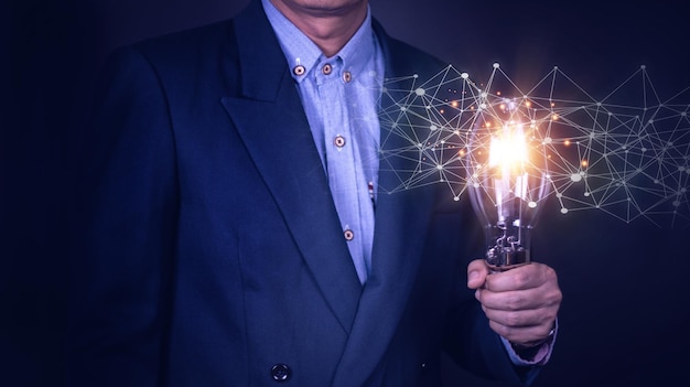 Businessman hand holding light bulb with finance document