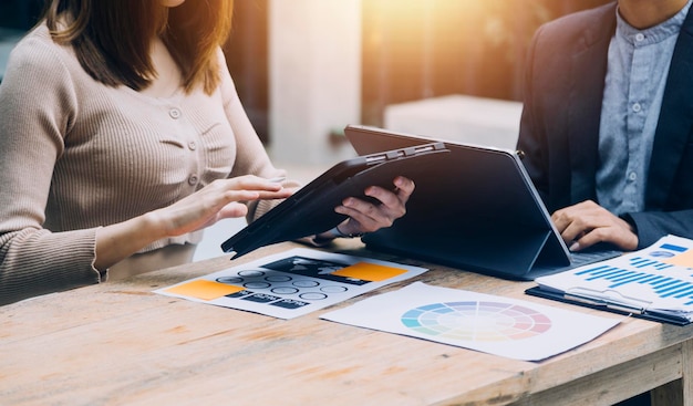 Businessman hand working digital marketing media in virtual screen with mobile phone and modern compute with VR icon diagram at office in morning light