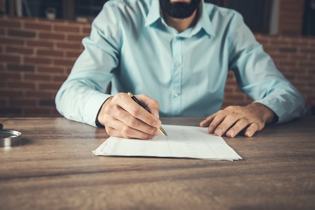 Businessman hand writing on document