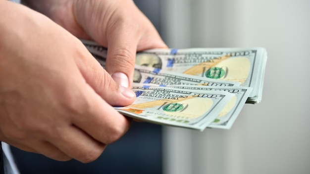 Businessman hands counting hundred dollar bills