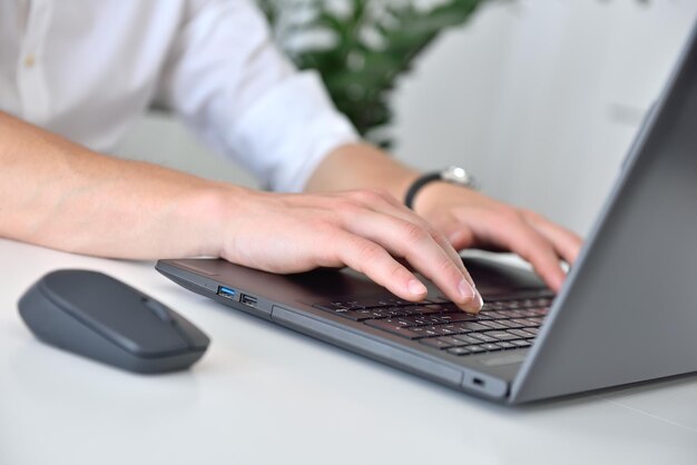 Businessman hands typing on laptop