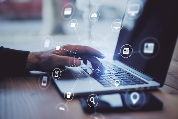 Businessman hands using laptop with abstract digital interface