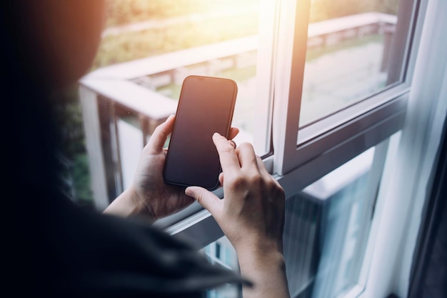 Businessman hands working with finances about cost and calculator and laptop with tablet smartphone at office in morning light