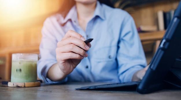 Businessman hands working with finances about cost and calculator and laptop with tablet smartphone at office in morning light