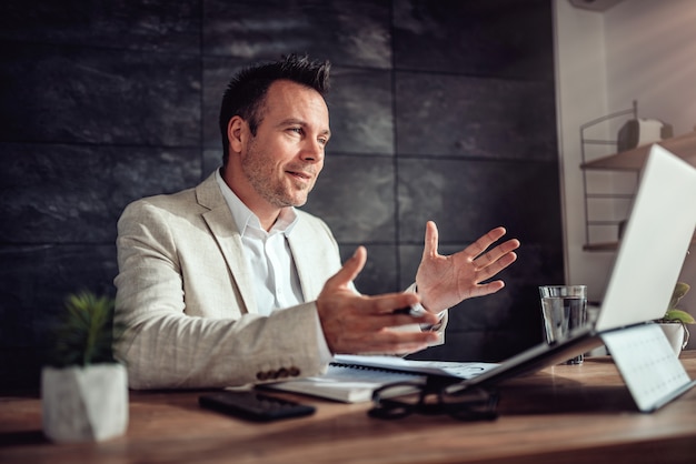 Businessman having online meeting in his office