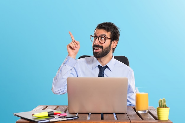 Businessman in his office thinking over white background on colorful background