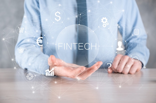 Businessman hold Fintech -financial technology concept.Business investment banking payment. Cryptocurrency investment and digital money. Business concept on virtual screen.