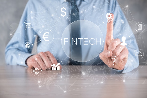 Businessman hold Fintech -financial technology concept.Business investment banking payment. Cryptocurrency investment and digital money. Business concept on virtual screen.