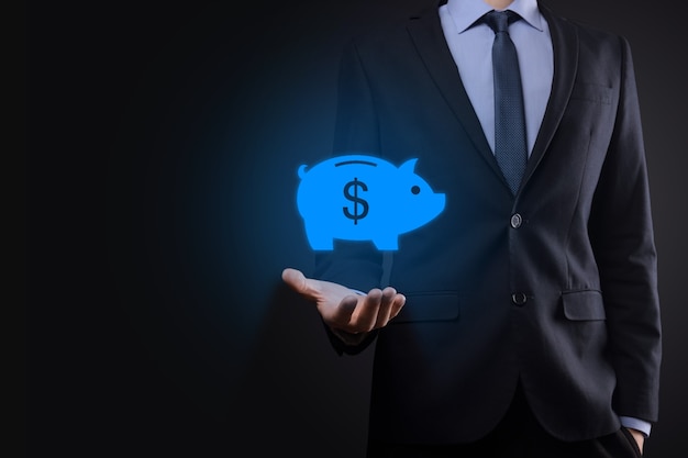 Businessman hold piggy bank icon .Business and Money spending planning, and investment budgeT