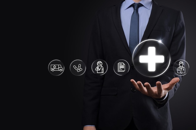 Photo businessman hold virtual plus medical network connection icons. covid-19 pandemic develop people awareness and spread attention on their healthcare.doctor,document,medicine,ambulance,patient icon.