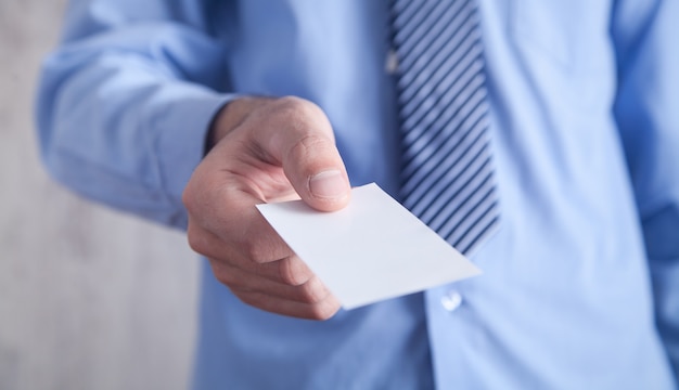 Businessman holding business card. Business concept