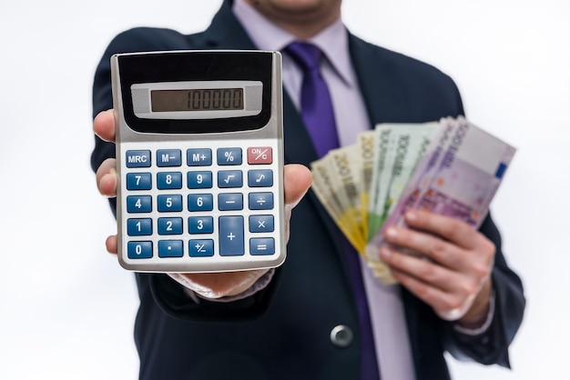 Businessman holding calculator and euro banknotes closeup