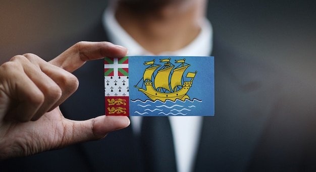 Businessman Holding Card of Saint Pierre and Miquelon Flag