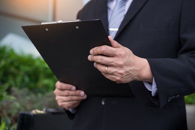 businessman holding a clipboard for working in outdoor