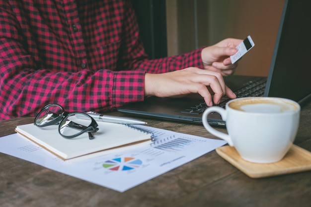 Businessman holding a credit card and using a laptop 