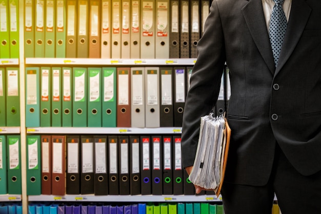 businessman holding data files