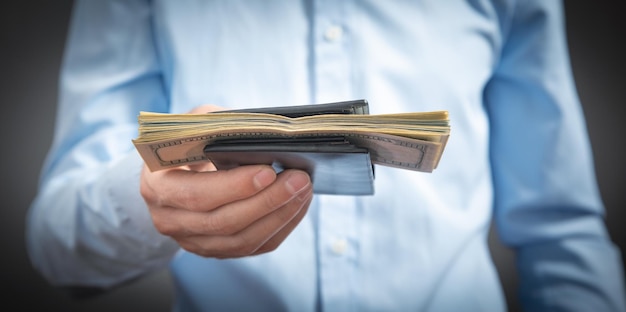 Businessman holding dollars with wallet