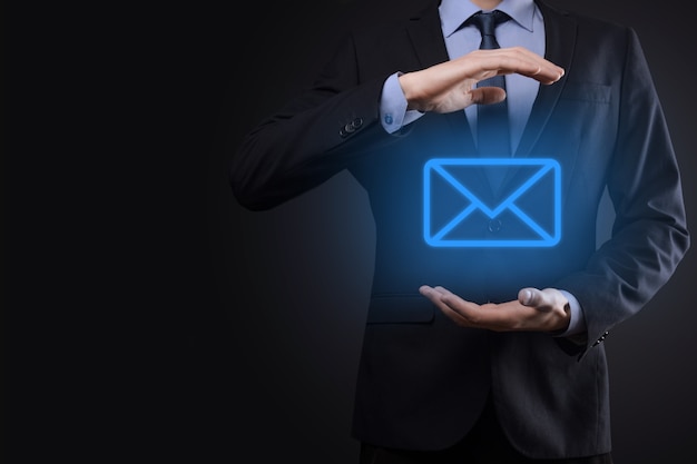 Businessman holding e-mail icon