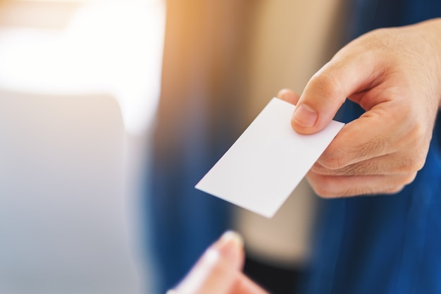 Businessman holding and giving empty business card