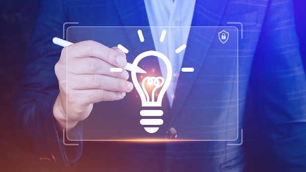 Businessman holding light bulb Bright ideaHands holding light bulb for concept new idea concept with innovation and inspiration technology in science and communication concept