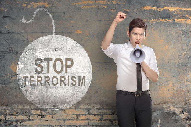 Businessman holding a megaphone with stop terrorism sign