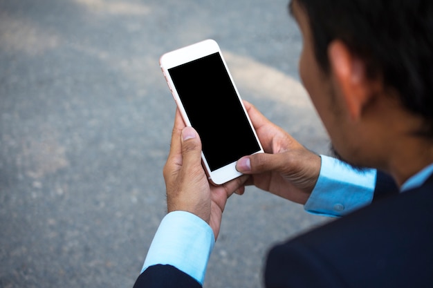 Businessman Holding Mobile Smart Phone and using Smart phone for Business connection