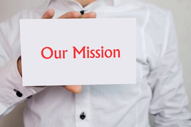 Businessman holding 'Our mission' text