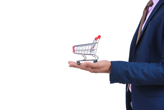 Businessman holding a red small shopping cart on white background isolated