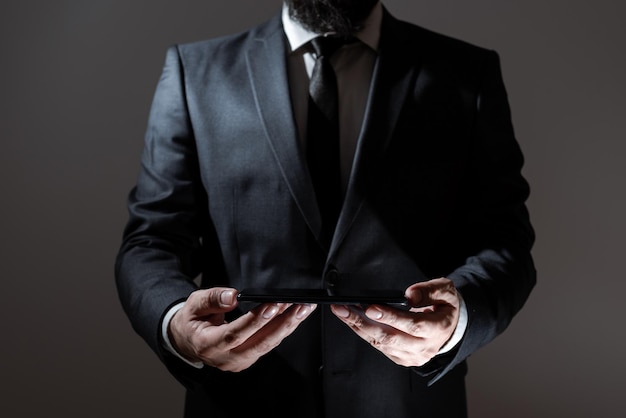 Businessman holding tablet with both hands and presenting important data man in suit showing