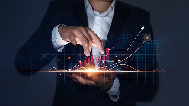 Businessman Holding Tablet with Growing Virtual Hologram of Statistics Graph and Chart