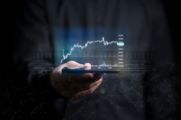 A Businessman holding tablet with stock and market graph economy statistic of growth and profitxA